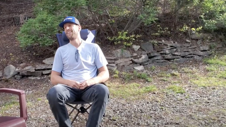 Man relaxing in the cascade mountain tech flex height sling chair