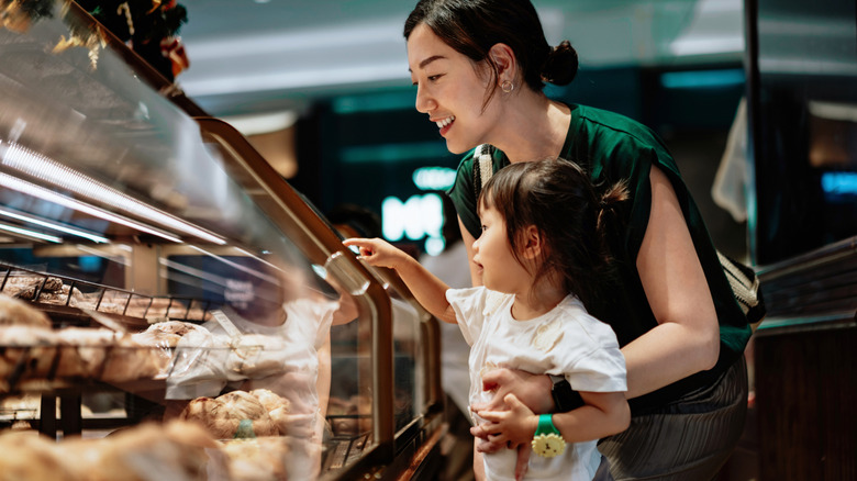 mother and child looking at food in a market
