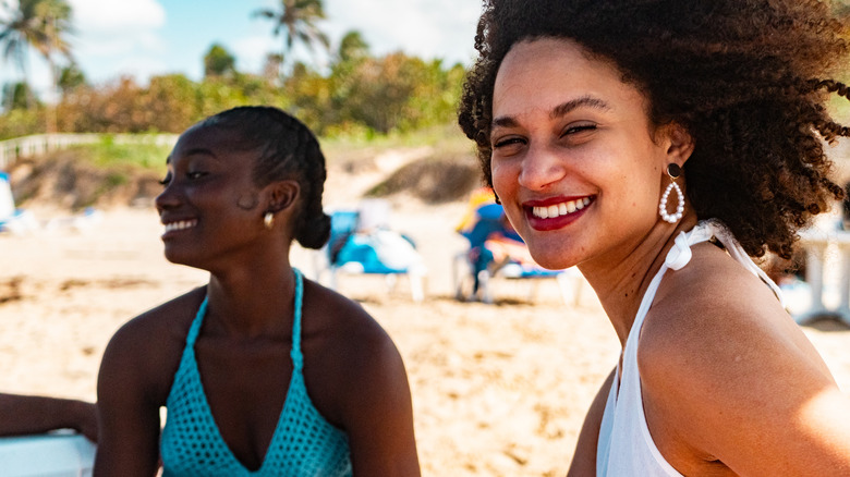 Two women smiling on a beach