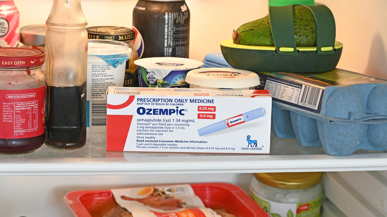 Ozempic package stands on refrigerator shelf