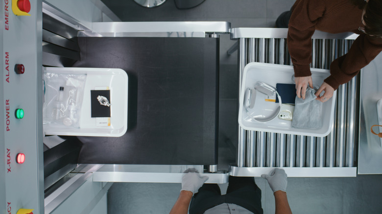 Bird's eye view of TSA trays on conveyor belt