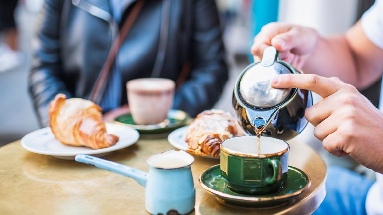 man pouring tea