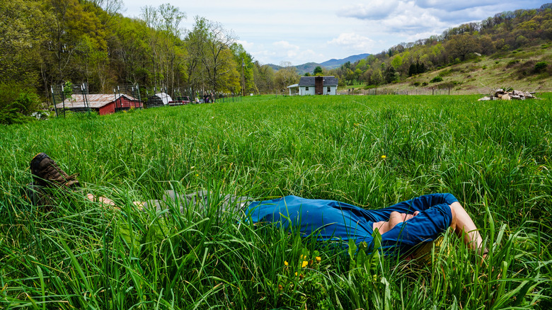 hiker laying in the grass resting