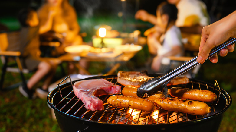 Cooking on a grill at a campsite.