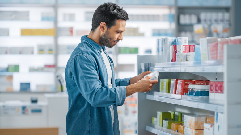 Man buying medicine at store