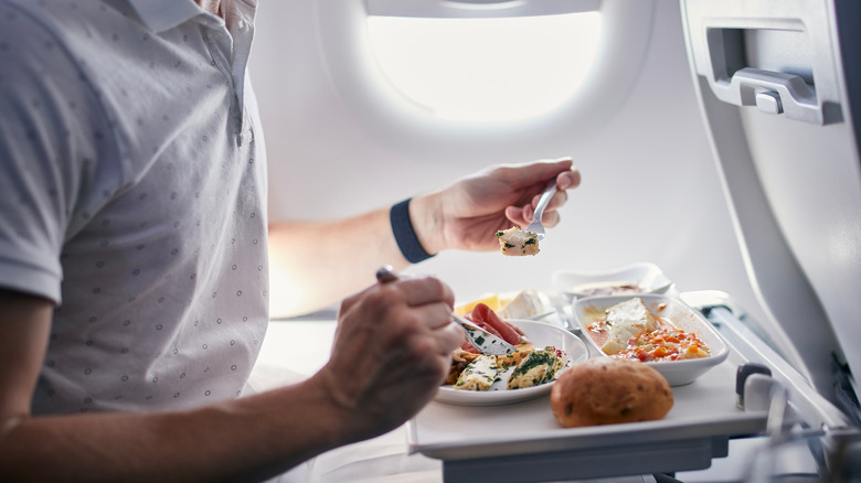 Person eating on airplane