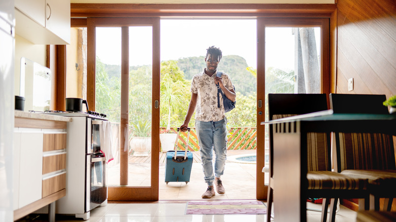 man walking into an Airbnb