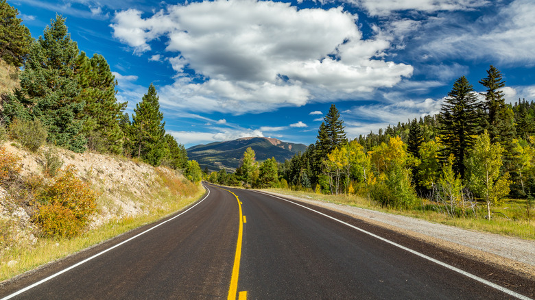 A road on the Enchanted Circle curves through highlands in New Mexico