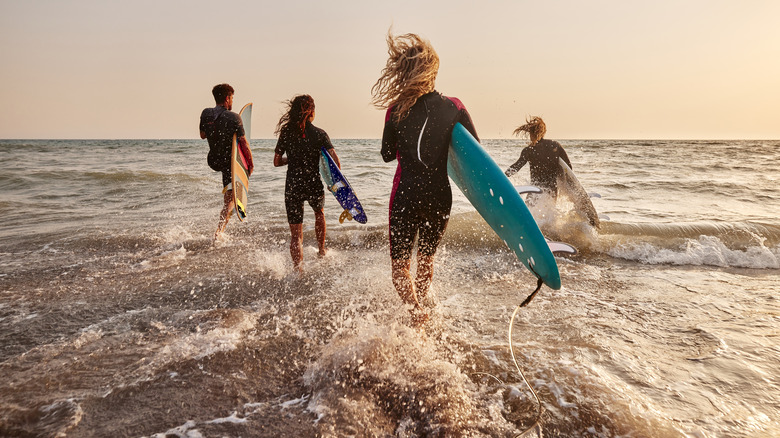 Surfers entering the water