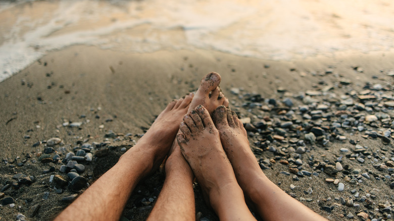 Pair of feet by the shoreline