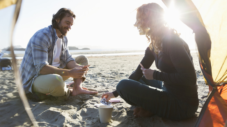 Two campers sitting on the beach