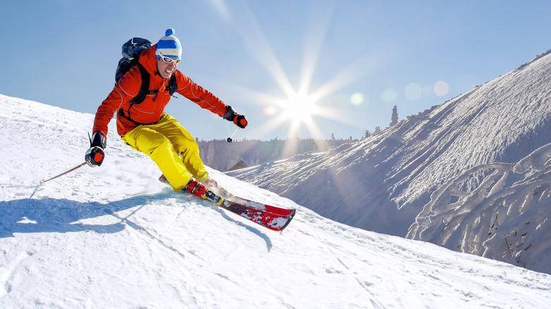 Male skiier going down mountain