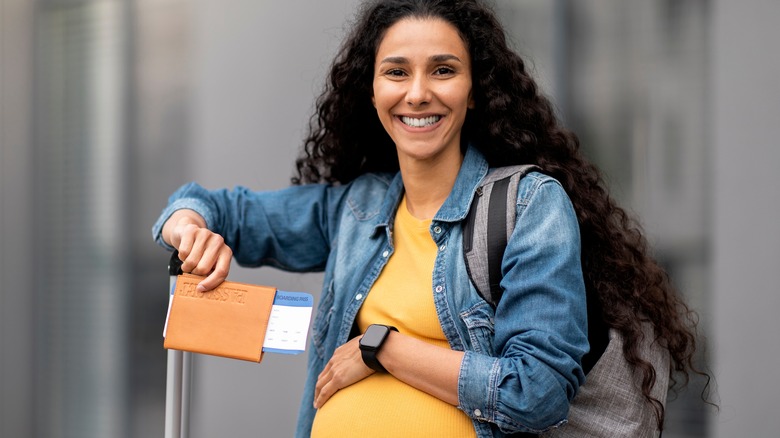 pregnant woman with suitcase