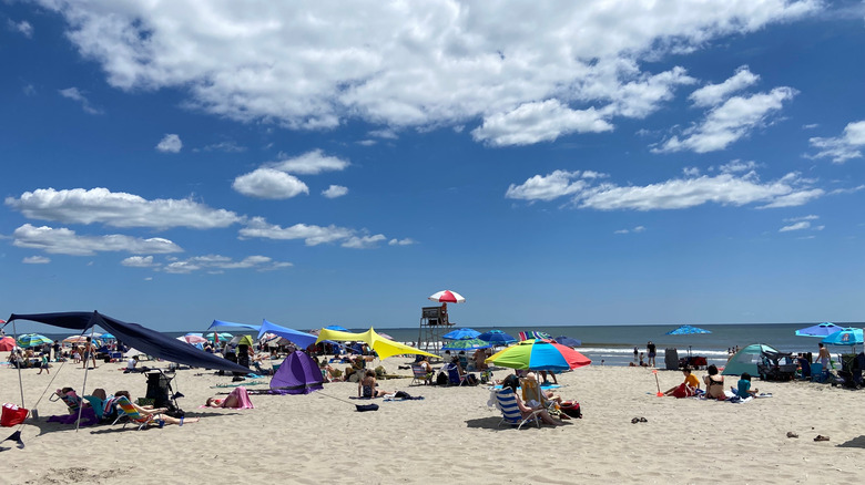 Multicolored umbrellas and people on Rockaway Beach in New York City