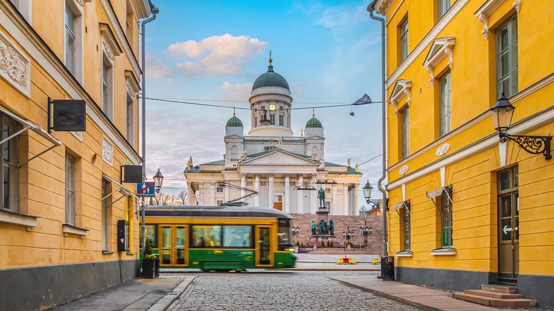 Moving tram and Helsinki Cathedral in the center of Helsinki, Finland at sunset