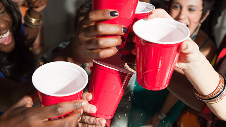 Hands clinking red Solo cups