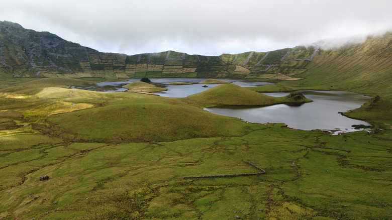 A lush, green volcanic landscape on Corvo Island, Portugal