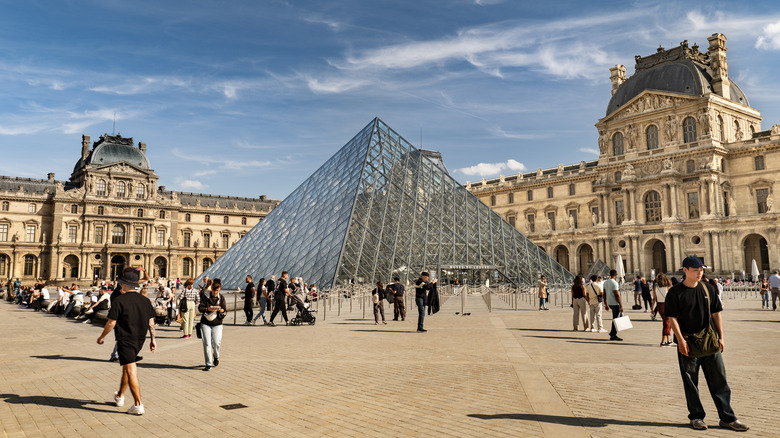 Tourists outside the Louvre in Paris, France