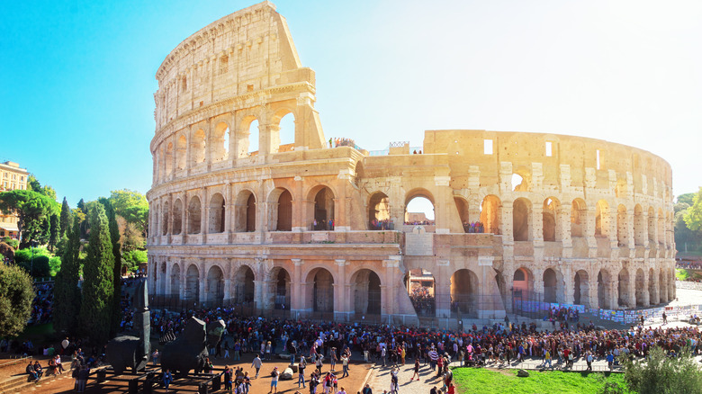 Crowds of tourists in front of the Colosseum in Rome