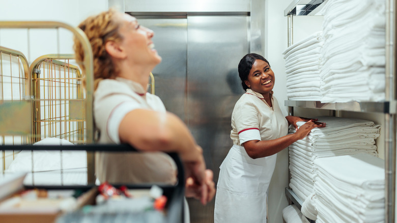 Two housekeepers in the laundry closet