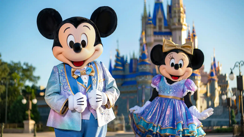 Mickey and Minnie Mouse in blue/purple 50th anniversary outfits