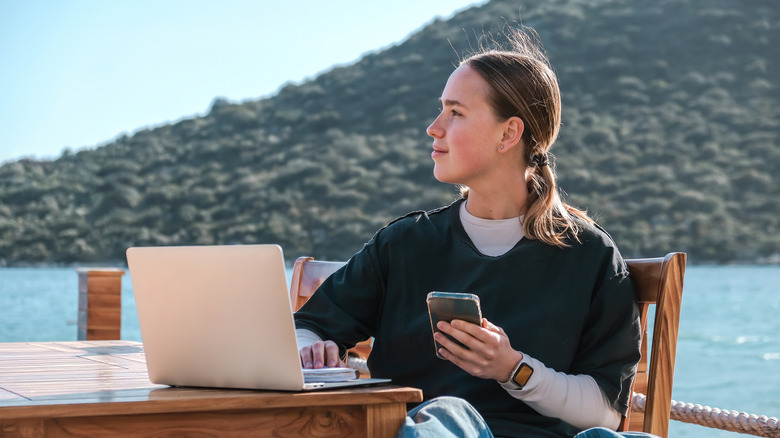 woman working remote near lake