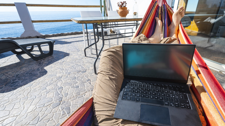 working on laptop in hammock