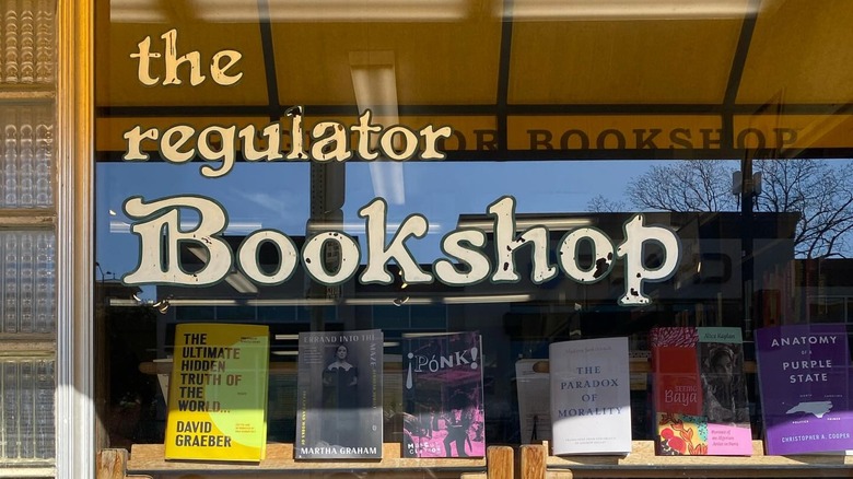 Books on display in a store window with signage that reads "The Regulator Bookshop"