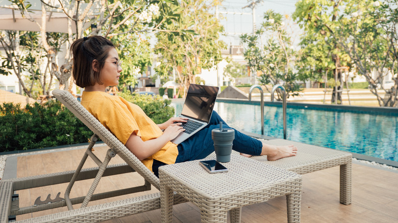 Woman working by a pool