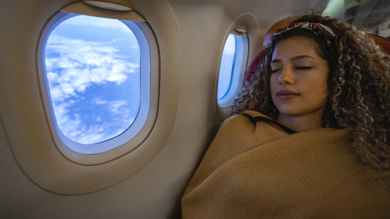 Woman sleeping on plane