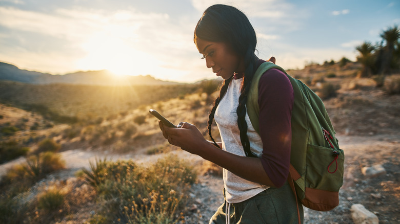 Hiker looking at her phone