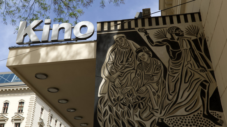 A large sign saying 'kino' with an artsy black-and-white picture next to it