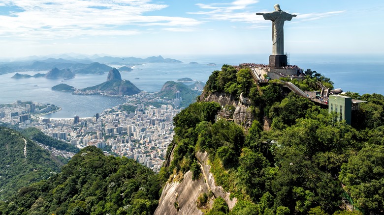 wide shot of Christ the Redeemer statue overlooking city in Brazil