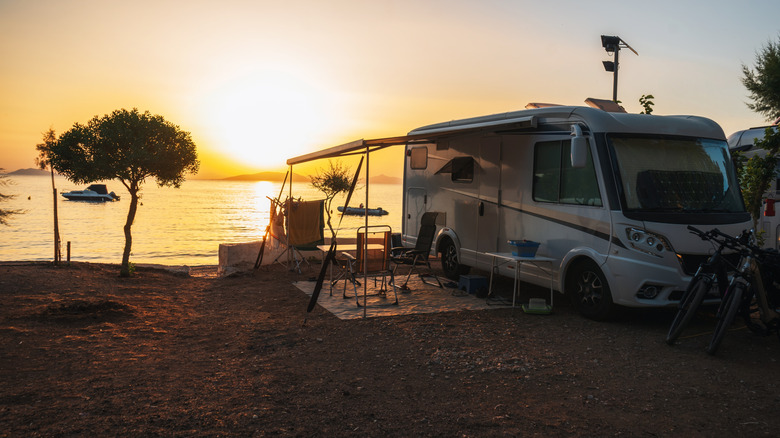 RV camper van on waterfront at sunset