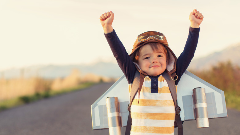 child wearing airplane costume