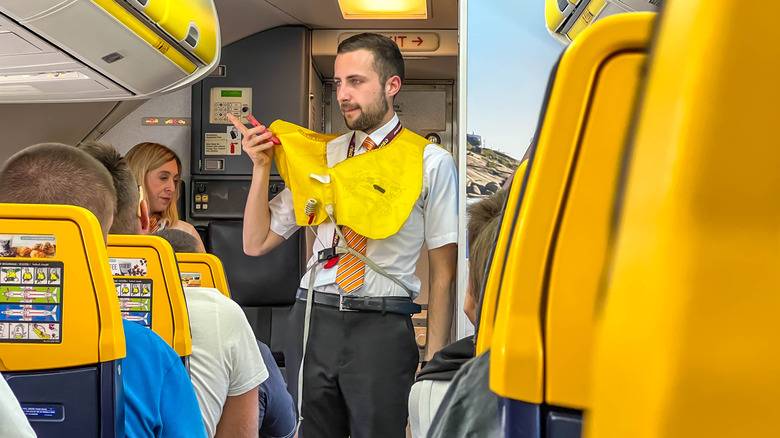 flight attendant performing safety demo