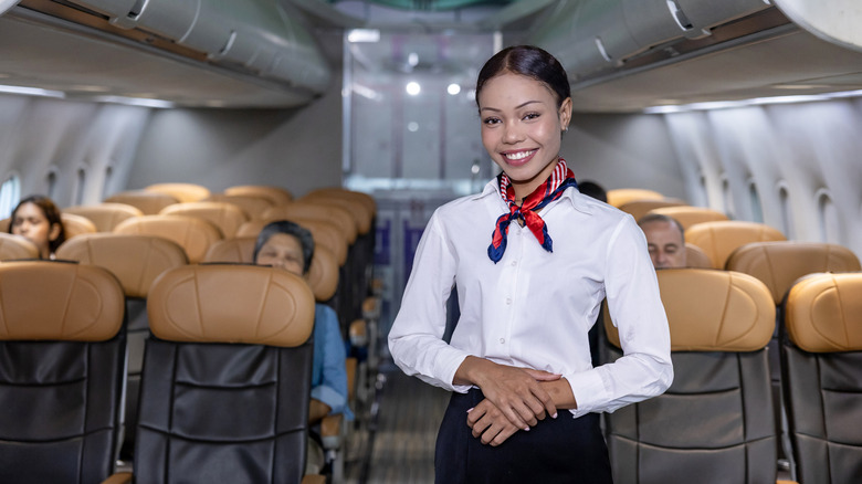 smiling flight attendant on plane