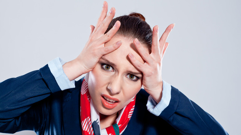 an exasperated female flight attendant