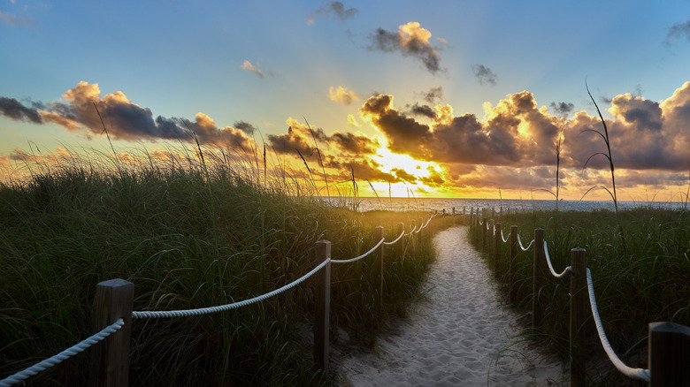 Sandy pathway to beach in Delray Beach, Florida, at sunset