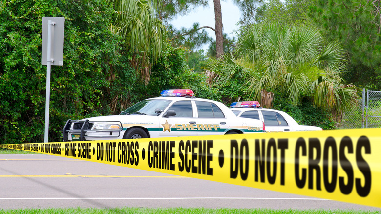 Police crime tape across the road in Florida