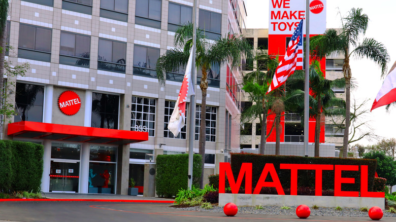 Office building with red features and signage that reads 