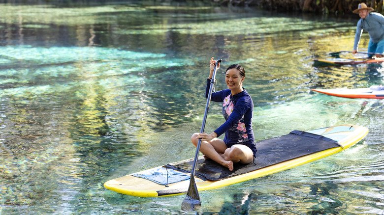 Traveler sitting on paddleboard