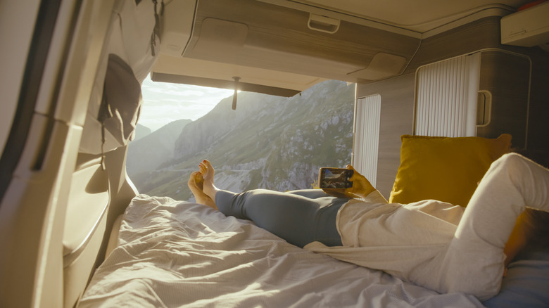 camper van owner laying in bed
