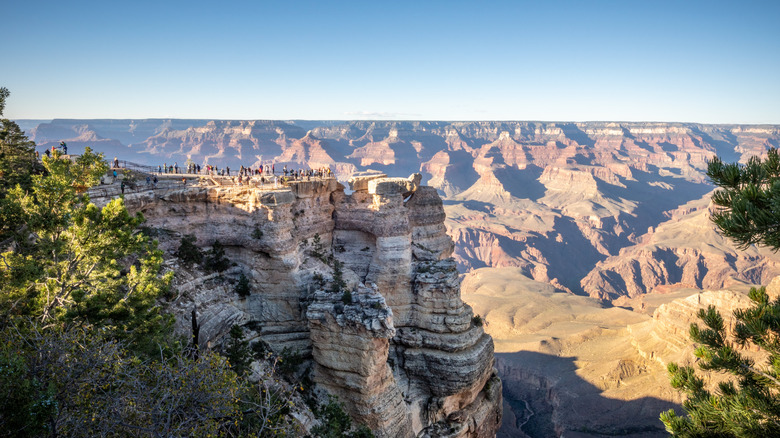 tourists stand at Mather Point, a lookout on the Grand Canyon's south rim