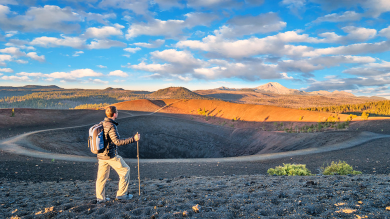a man hiking at the top of Cinder Cone Trail in Lassen Volcanic National Park