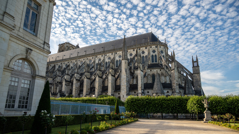 The facade of Bourges Cathedral against a cloudy sky