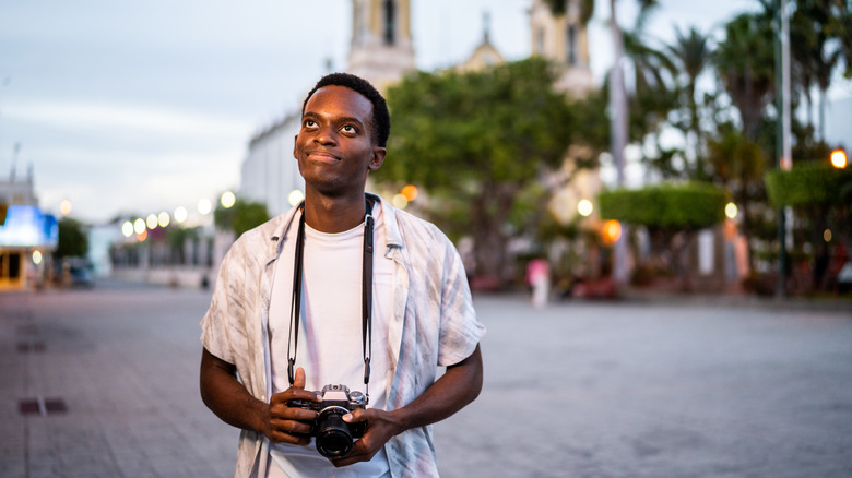 man alone with camera