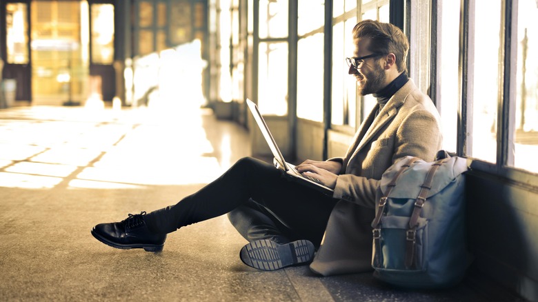 Man on ground bag computer