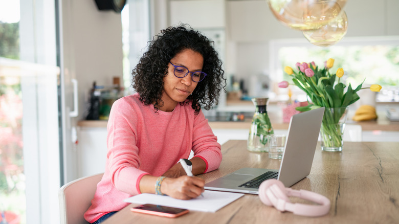 Traveler taking notes from laptop