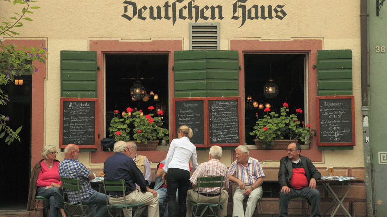 Men sitting outside a traditional German restaurant